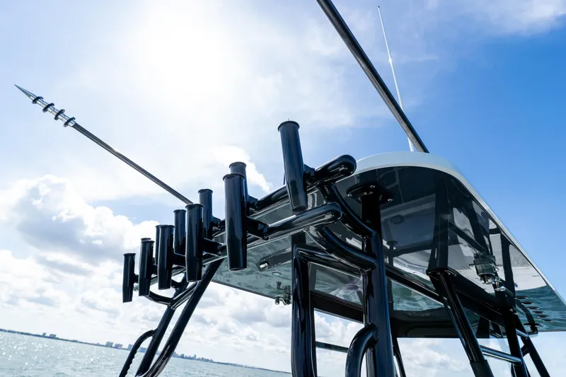 Slide: The Image of 2026 Invincible 33 Catamaran with fishing rod holders against a clear blue sky. - 34