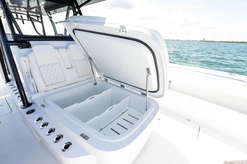 Slide: The Image of Open storage compartment on 2026 Invincible 33 Catamaran, featuring luxurious seating and ocean backdrop. - 37