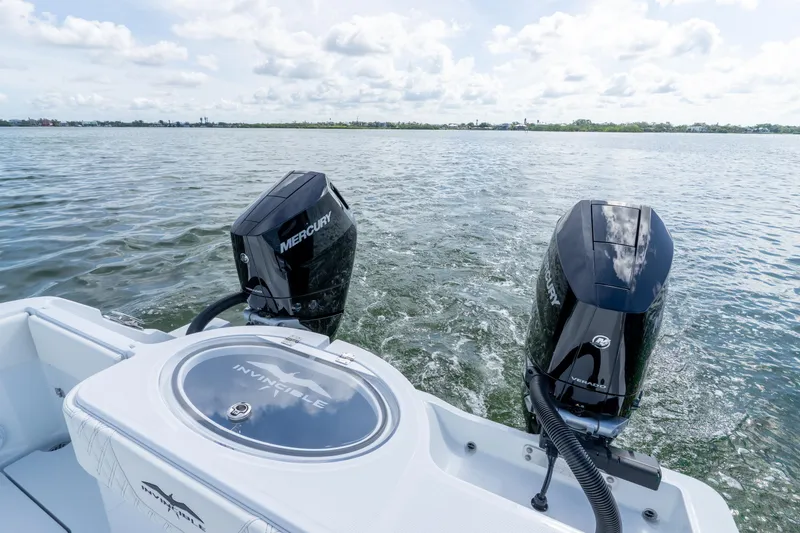 Slide: The Image of Invincible 33 Catamaran 2026 with dual Mercury outboard engines on open water. - 4