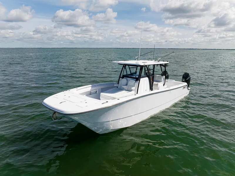 Slide: The Image of 2026 Invincible 33 Catamaran on calm ocean waters under a partly cloudy sky. - 40