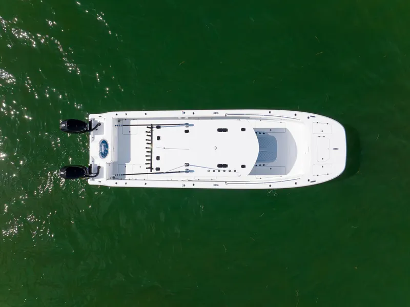 Slide: The Image of Aerial view of 2026 Invincible 33 Catamaran on green water. - 43