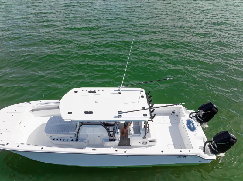 Slide: The Image of 2026 Invincible 33 Catamaran on green water, aerial view, featuring dual Mercury engines. - 45