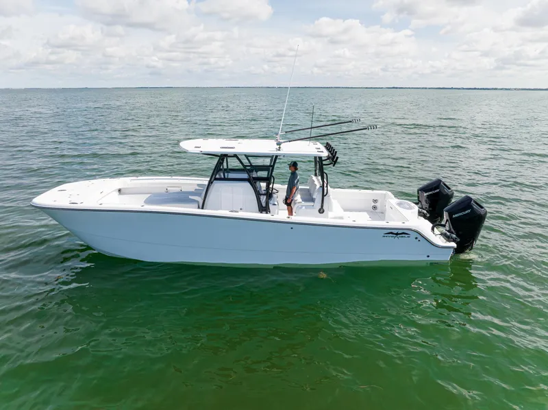 Slide: The Image of 2026 Invincible 33 Catamaran on calm water, featuring dual outboard motors. - 46