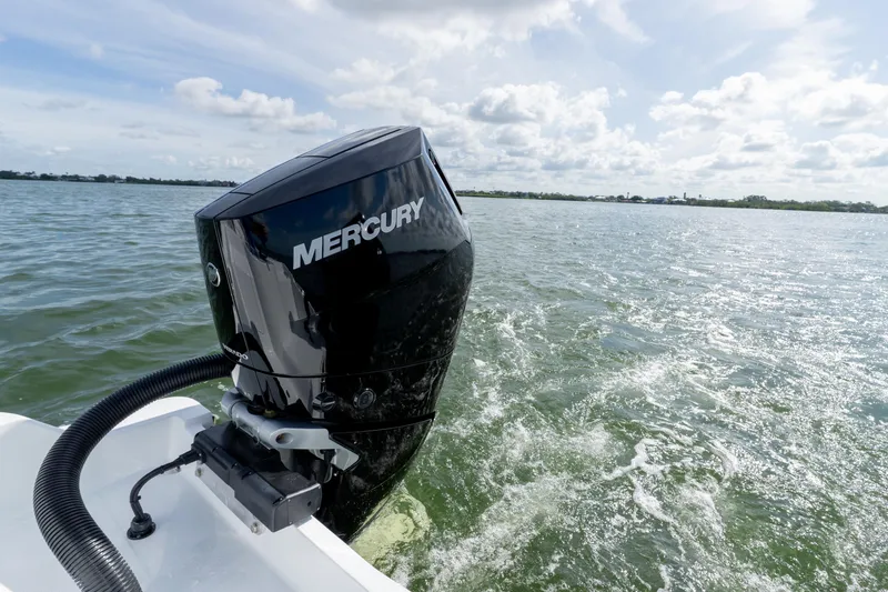 Slide: The Image of Outboard motor on 2026 Invincible 33 Catamaran cruising through water. - 6
