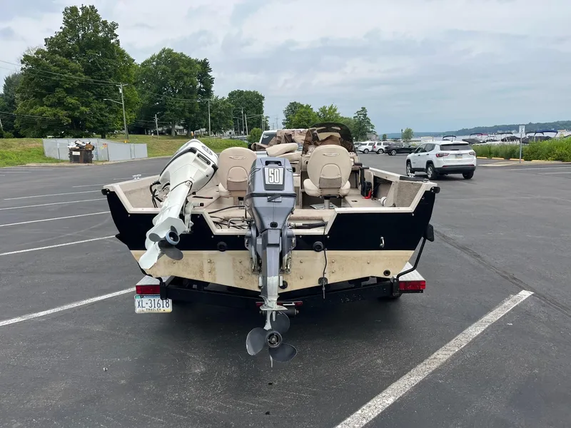 Slide: The Image of 2001 Crestliner 1750 Fish Hawk SC boat on trailer in parking lot. - 3