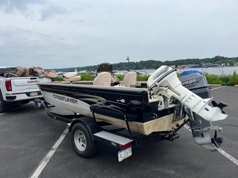 Slide: The Image of 2001 Crestliner 1750 Fish Hawk SC boat on trailer, parked near a lake. - 4