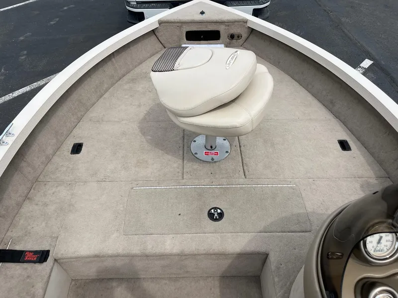 Slide: The Image of 2001 Crestliner 1750 Fish Hawk SC boat interior with beige seating and carpeted deck. - 6