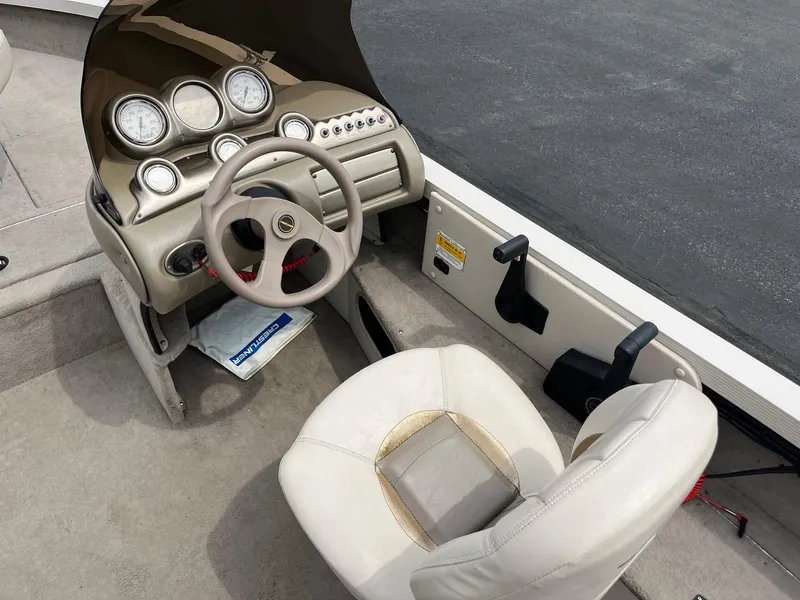 Slide: The Image of 2001 Crestliner 1750 Fish Hawk SC boat interior with steering wheel and dashboard controls. - 7