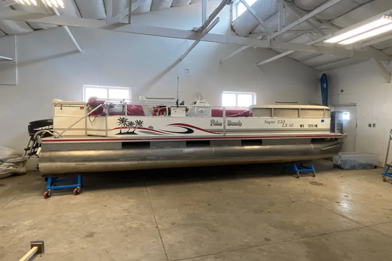 The Image of 2007 Palm Beach 220 LX pontoon boat in indoor storage facility. - 0