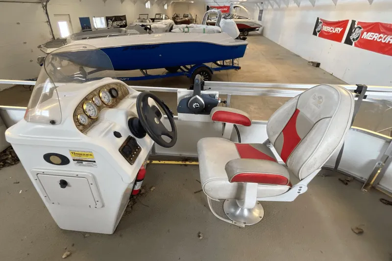 Slide: The Image of 2007 Palm Beach 220 LX boat interior with steering console and captain's chair. - 3