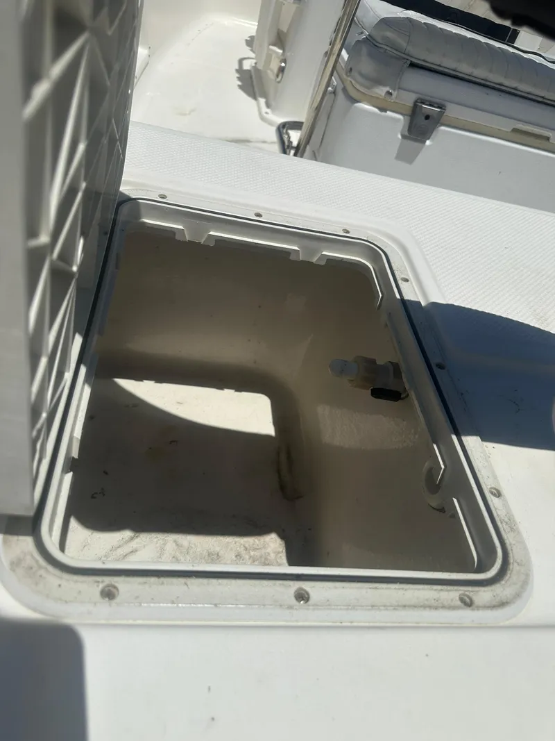 Slide: The Image of Open storage compartment on a 2009 Key West 176 Bay Reef boat. - 13
