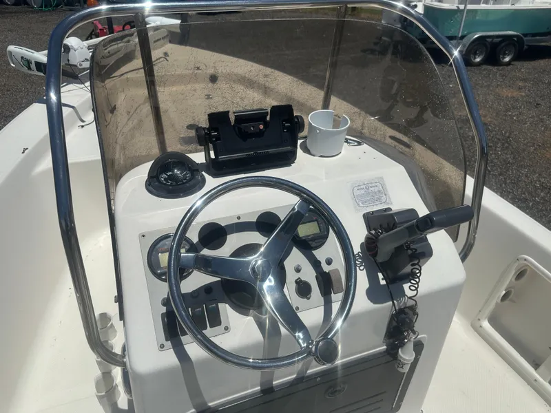 Slide: The Image of 2009 Key West 176 Bay Reef boat console with steering wheel and controls. - 14