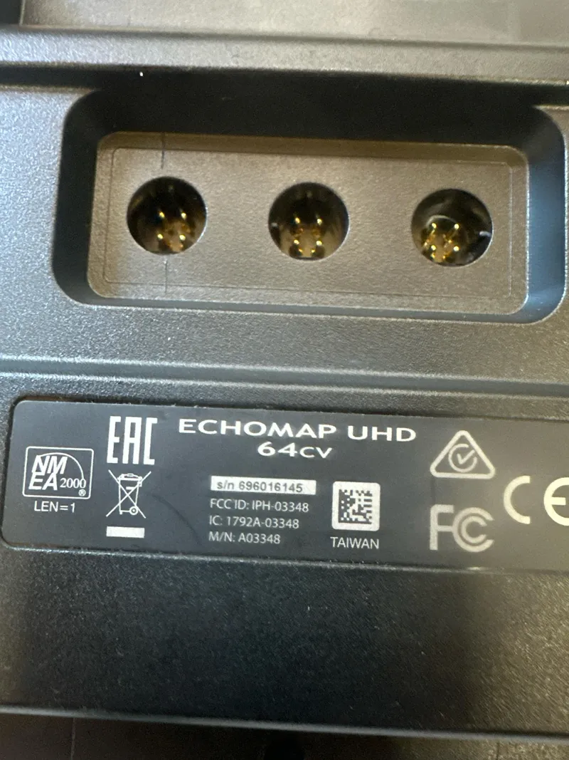 Slide: The Image of Close-up of Garmin ECHOMAP UHD 64cv connector panel with serial and certification labels. - 18