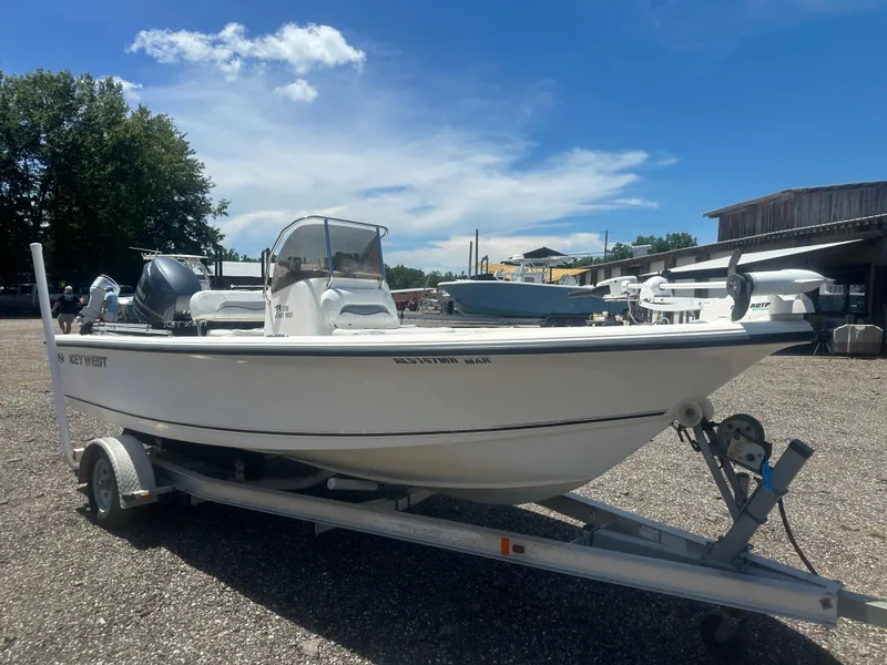 Slide: The Image of 2009 Key West 176 Bay Reef boat on trailer under clear blue sky. - 8