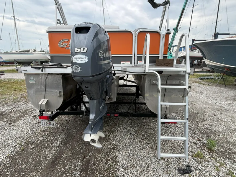 Slide: The Image of 2018 SunCatcher V16 Cruise pontoon boat with Yamaha 60 engine, docked on gravel. - 2