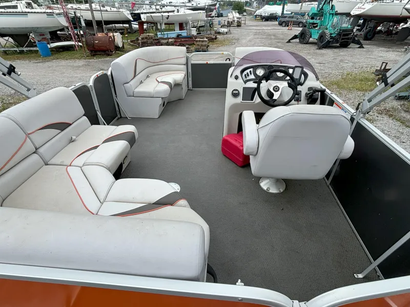 Slide: The Image of 2018 SunCatcher V16 Cruise pontoon boat interior with seating and steering console. - 3