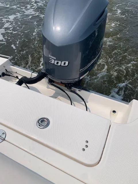 Slide: The Image of 2014 Robalo R247 Dual Console with Yamaha 300 outboard engine on water. - 4