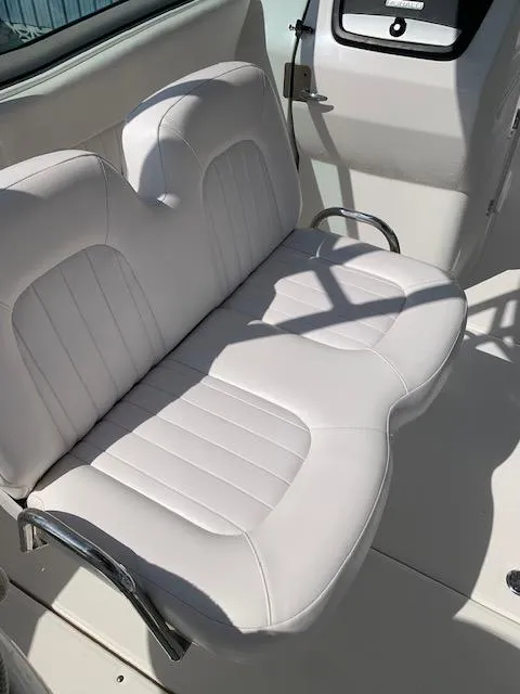 Slide: The Image of White cushioned seating on 2014 Robalo R247 Dual Console boat. - 5