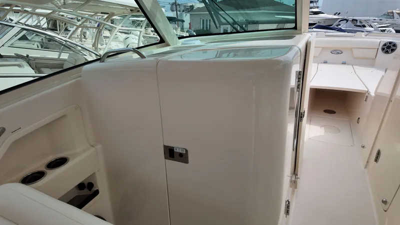 Slide: The Image of 2026 Grady-White Freedom 325 boat interior, featuring seating and storage compartments. - 15