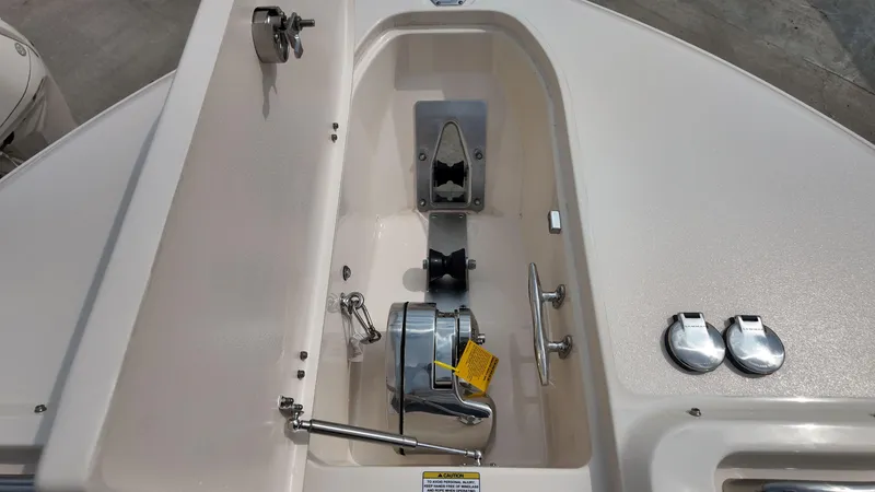 Slide: The Image of Anchor compartment of 2026 Grady-White Freedom 325 boat, featuring stainless steel fittings. - 19