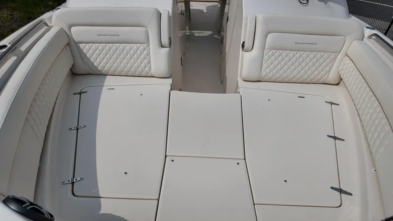 Slide: The Image of 2026 Grady-White Freedom 325 boat interior with cushioned seating and storage compartments. - 21