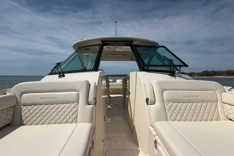 Slide: The Image of 2026 Grady-White Freedom 325 boat with luxurious seating and open sea view. - 23