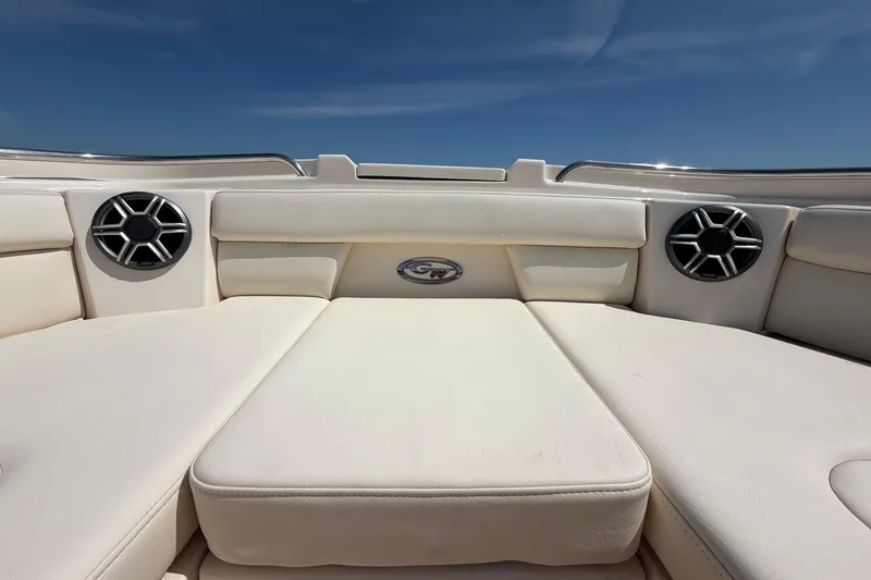 Slide: The Image of 2026 Grady-White Freedom 325 boat interior with cushioned seating and speakers. - 24