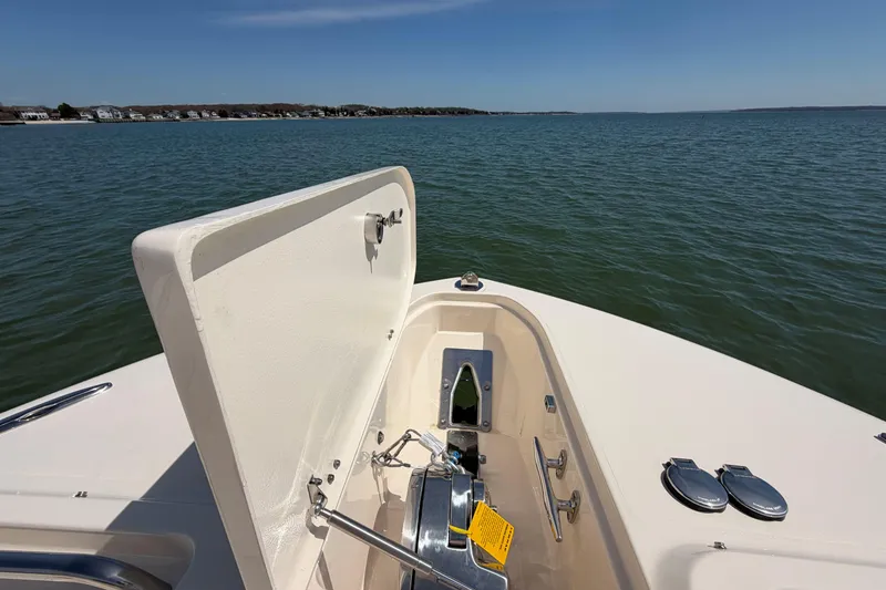 Slide: The Image of 2026 Grady-White Freedom 325 boat with open anchor hatch on calm water. - 25