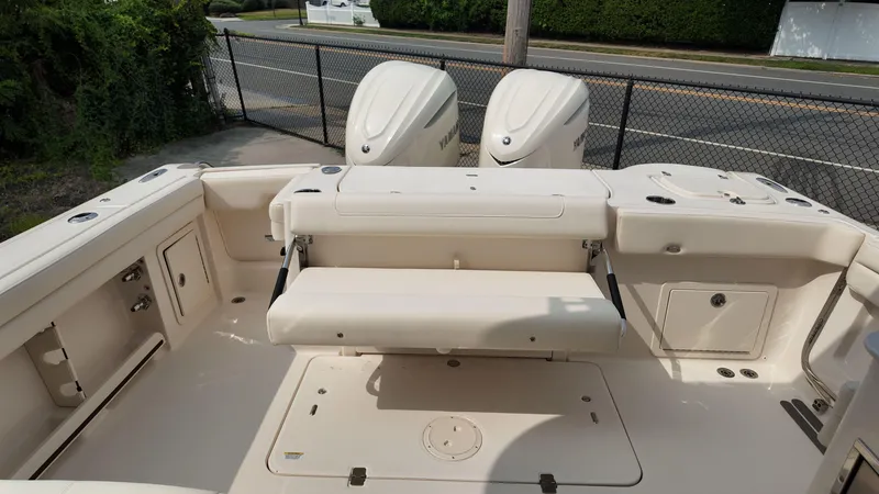 Slide: The Image of 2026 Grady-White Freedom 325 boat interior with seating and dual outboard motors. - 3