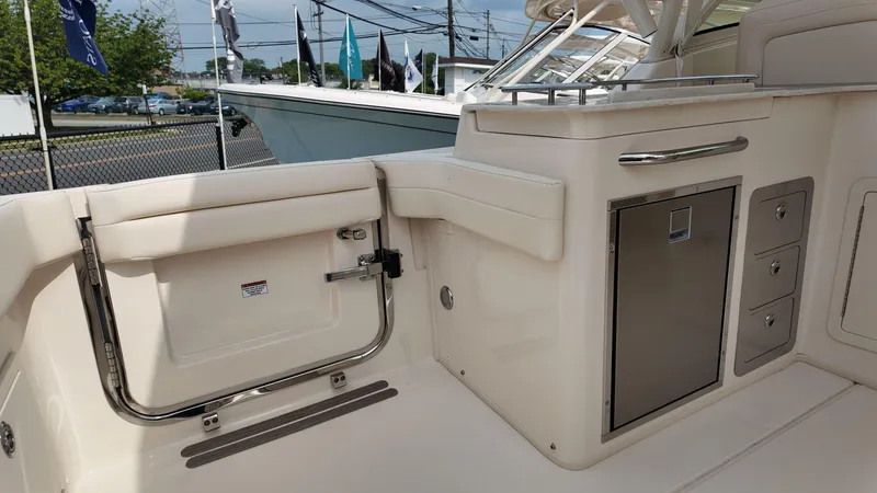 Slide: The Image of 2026 Grady-White Freedom 325 boat interior with storage compartments and seating area. - 6