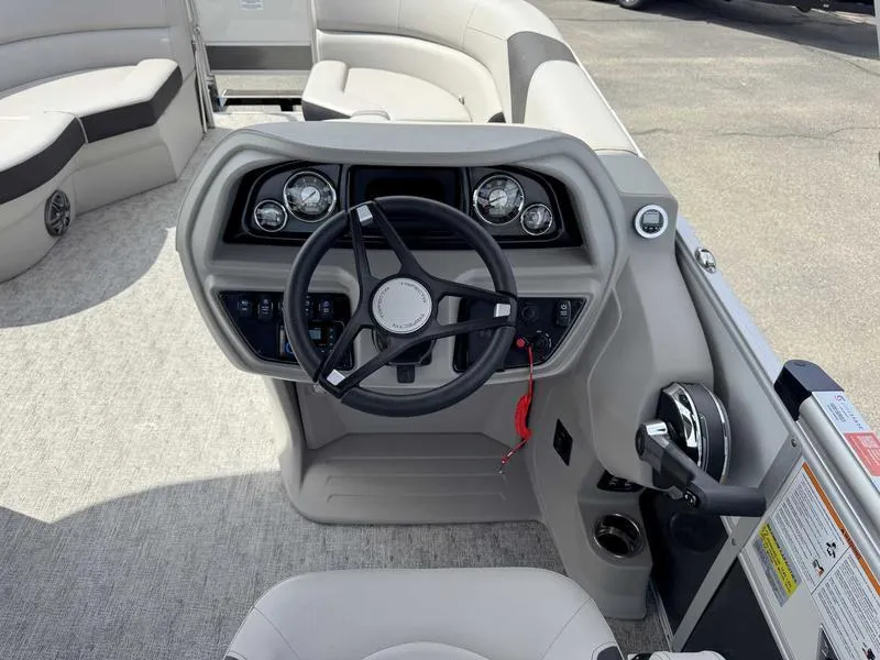 Slide: The Image of 2025 Trifecta 22TRFC LE boat dashboard with steering wheel and controls. - 10