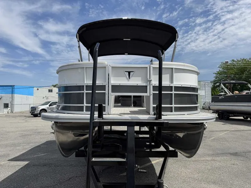 Slide: The Image of 2025 Trifecta 22TRFC LE pontoon boat in a parking lot, viewed from the front. - 9