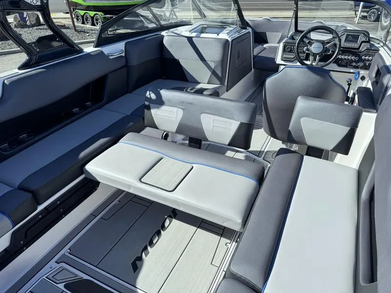 Slide: The Image of 2020 Moomba Max boat interior with modern seating and steering console. - 12