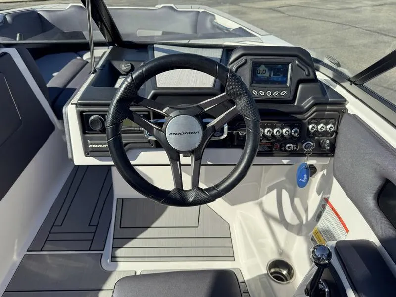 Slide: The Image of 2020 Moomba Max boat dashboard with steering wheel and control panel. - 13