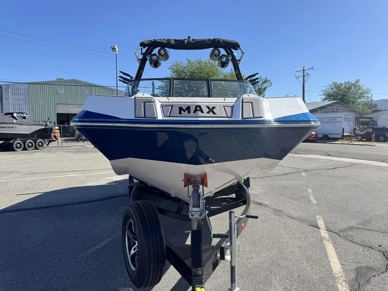 Slide: The Image of 2020 Moomba Max boat on trailer in parking lot, sunny day. - 2