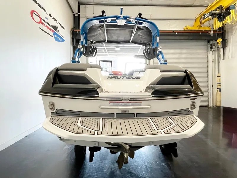 Slide: The Image of 2020 Nautique G21 boat in showroom, rear view with swim platform and wakeboard tower. - 5
