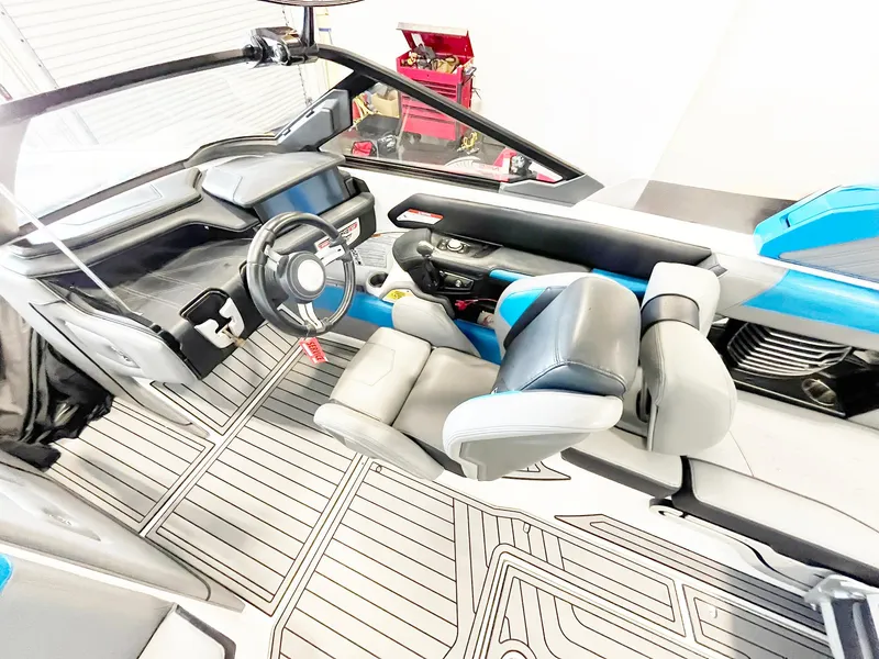 Slide: The Image of 2020 Nautique G21 boat interior with modern dashboard and seating. - 8
