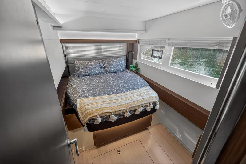 Slide: The Image of Luxurious bedroom interior of 2022 Leopard 53 Powercat yacht with large windows and cozy bedding. - 100