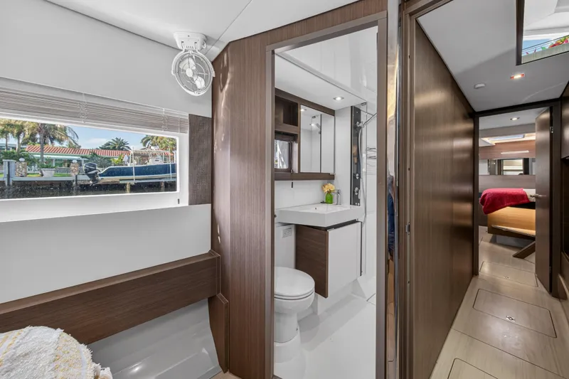 Slide: The Image of Interior of 2022 Leopard 53 Powercat yacht, featuring modern bathroom and cozy cabin. - 104