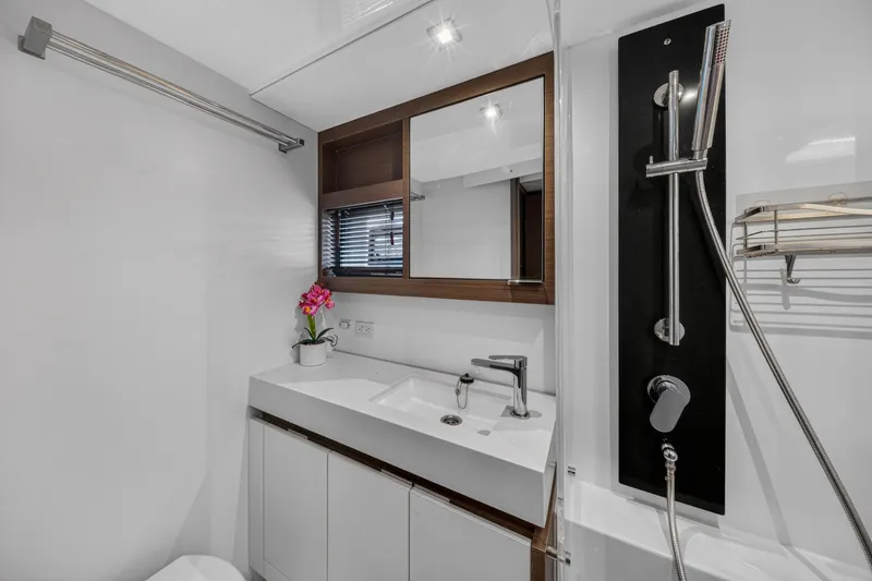 Slide: The Image of Modern bathroom in 2022 Leopard 53 Powercat yacht with sleek fixtures and floral decor. - 113