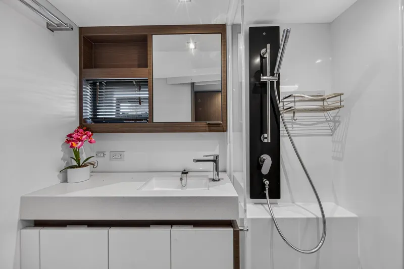 Slide: The Image of Modern bathroom on 2022 Leopard 53 Powercat yacht with sleek fixtures and floral decor. - 114