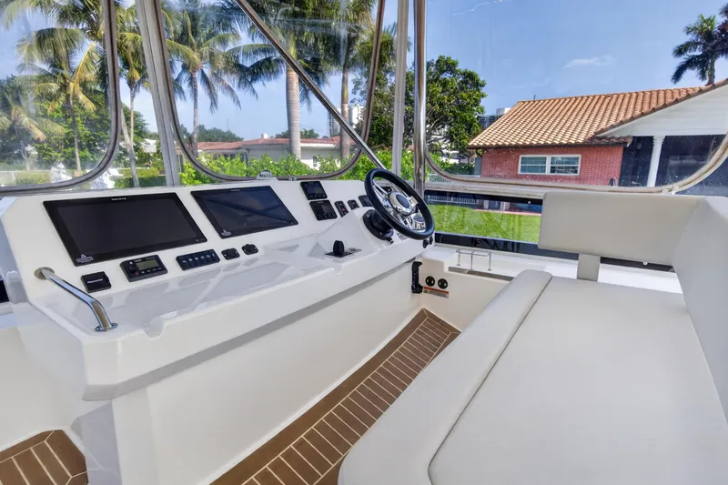 Slide: The Image of Interior helm of 2022 Leopard 53 Powercat with modern controls and panoramic windows. - 12