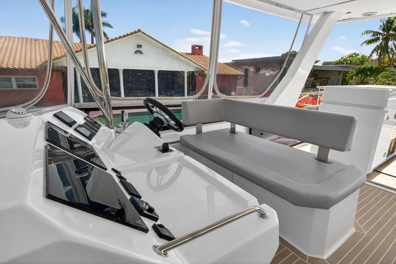 Slide: The Image of Interior view of 2022 Leopard 53 Powercat helm with modern controls and seating. - 18