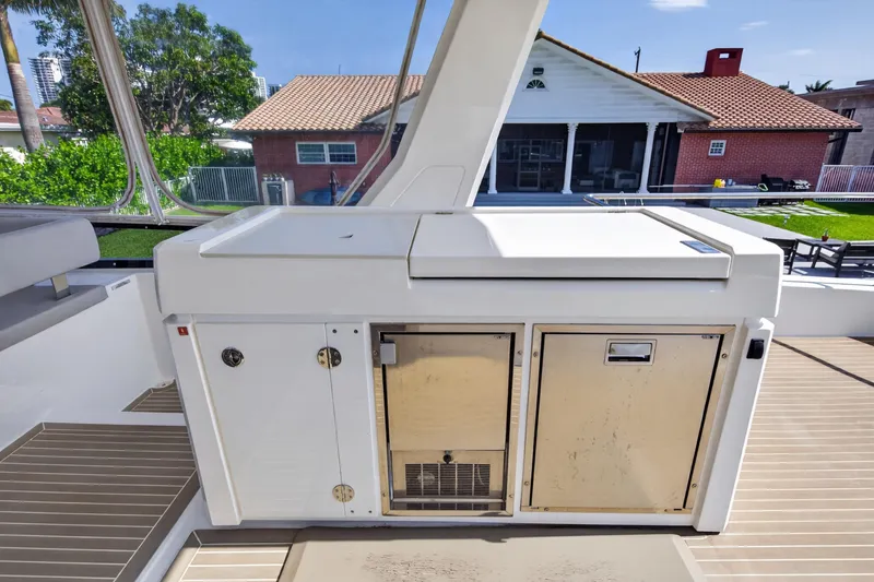 Slide: The Image of Outdoor kitchen area on a 2022 Leopard 53 Powercat yacht, featuring storage and appliances. - 24