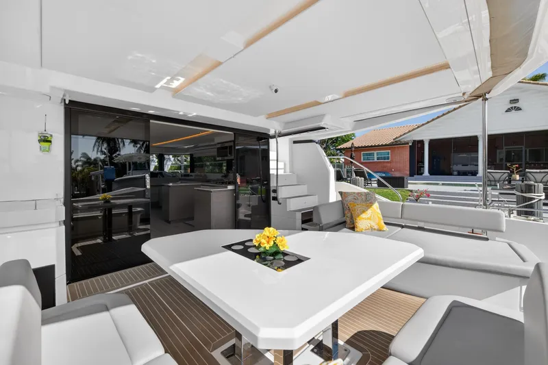 Slide: The Image of Luxurious 2022 Leopard 53 Powercat yacht interior with modern seating and elegant table setting. - 33