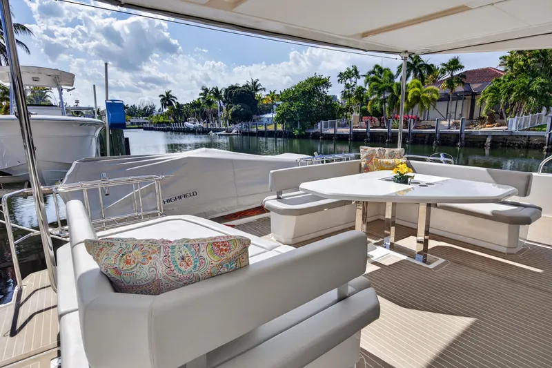 Slide: The Image of Luxurious 2022 Leopard 53 Powercat yacht with elegant outdoor seating and scenic waterfront view. - 37