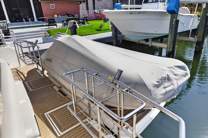 Slide: The Image of Covered boat on Leopard 53 Powercat 2022 docked near waterfront home. - 42