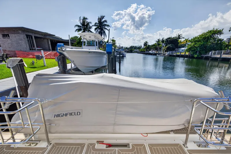 Slide: The Image of 2022 Leopard 53 Powercat docked near a serene waterfront with covered boat. - 43