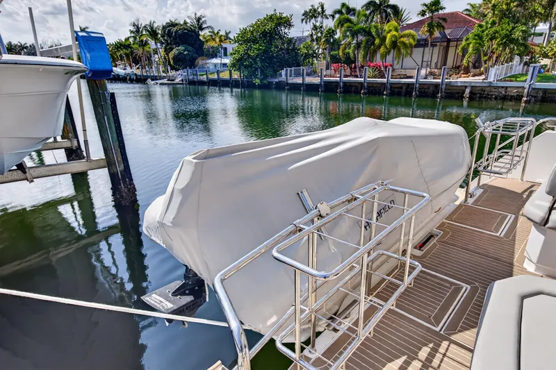 Slide: The Image of 2022 Leopard 53 Powercat docked, covered, with scenic waterfront view. - 44