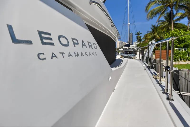 Slide: The Image of 2022 Leopard 53 Powercat yacht docked, showcasing sleek design and branding. - 47